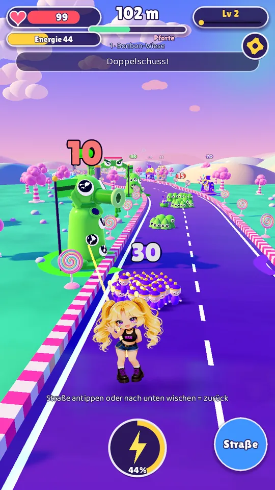 Gameplay: a green slime tower at the roadside, Waxi and her fans heading towards it.